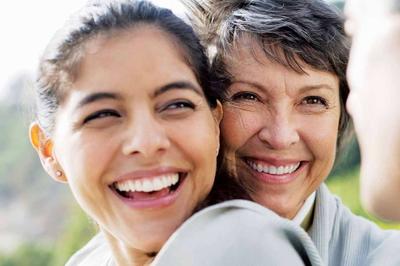 Mother and daughter hugging and smiling
