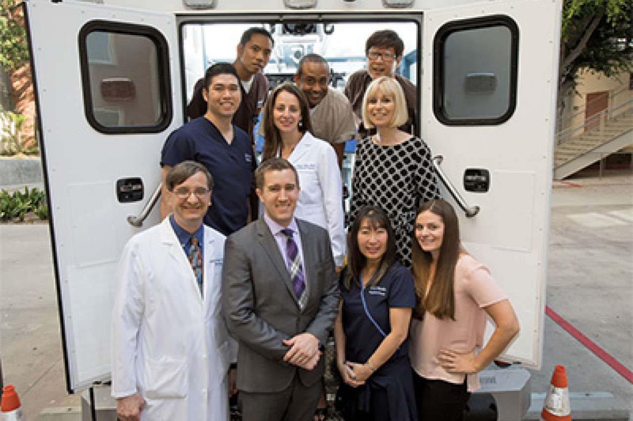 a group of medical professionals in the back of a Mobile Stroke Unit