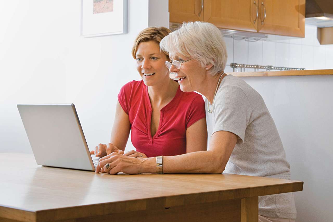 Two woman using a laptop