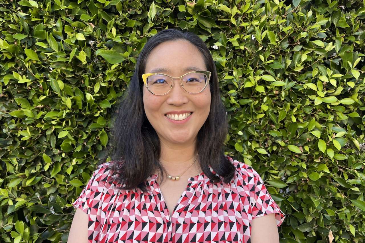 Dr. Vivian Chang, smiling in front of greenery