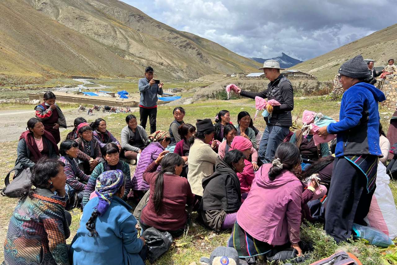 A nurse and doctor hand out hygiene kits in a remote area of the Himalayas