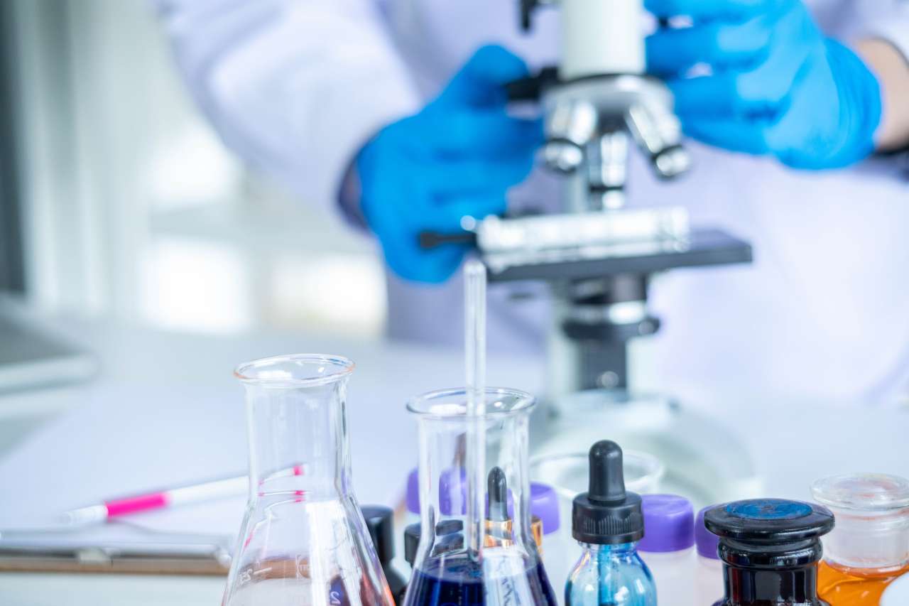 Cancer researcher working at a microscope