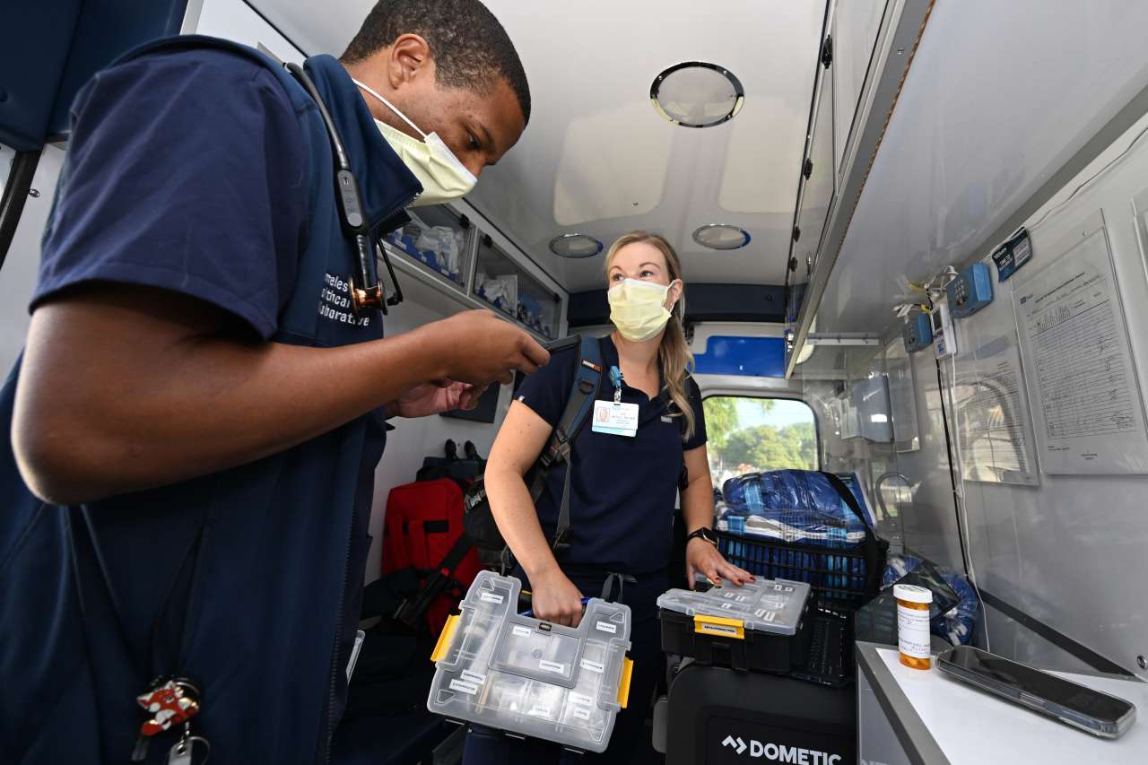 Dr. Phillip Brown works with nurse Zoe McFall inside a Homeless Healthcare Collaborative mobile van.
