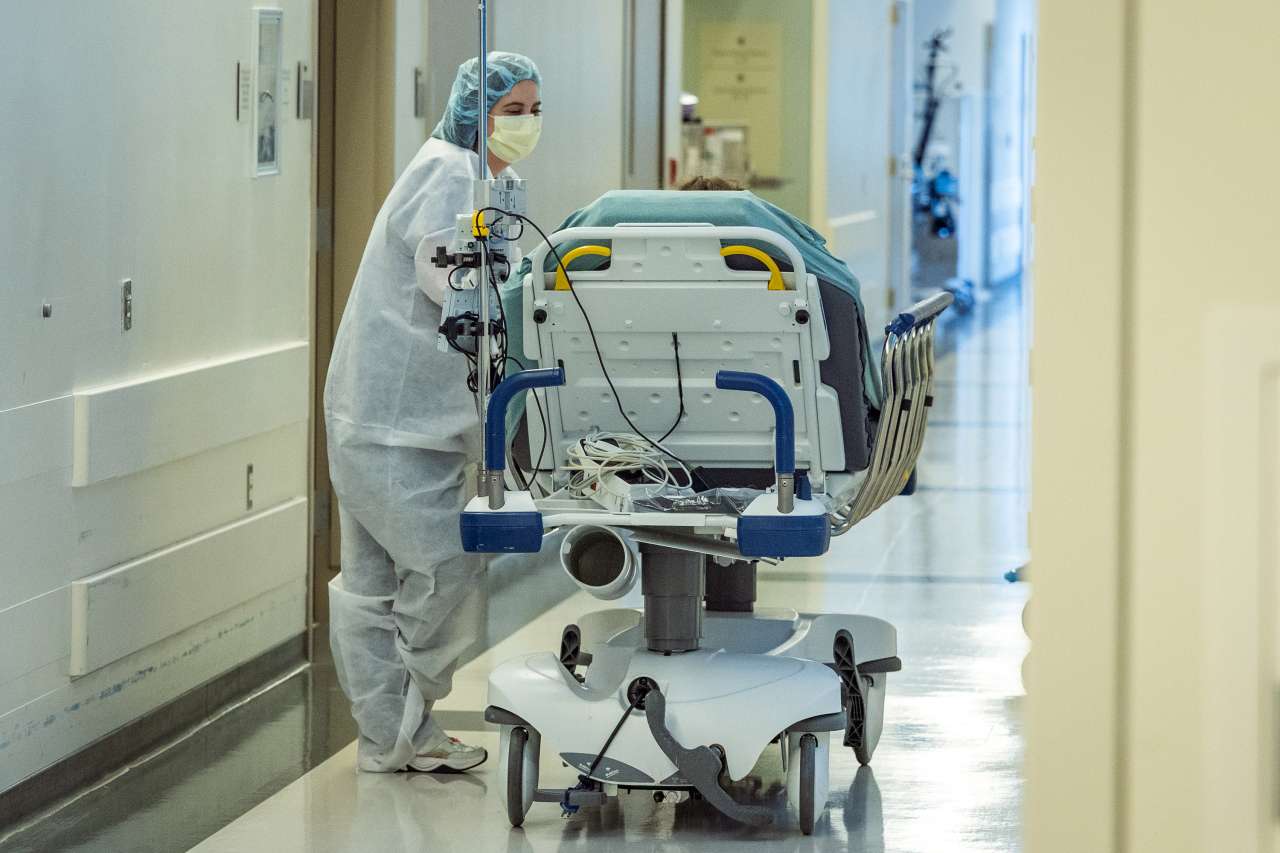 A Chase Child Life Specialist with a patient on a gurney.