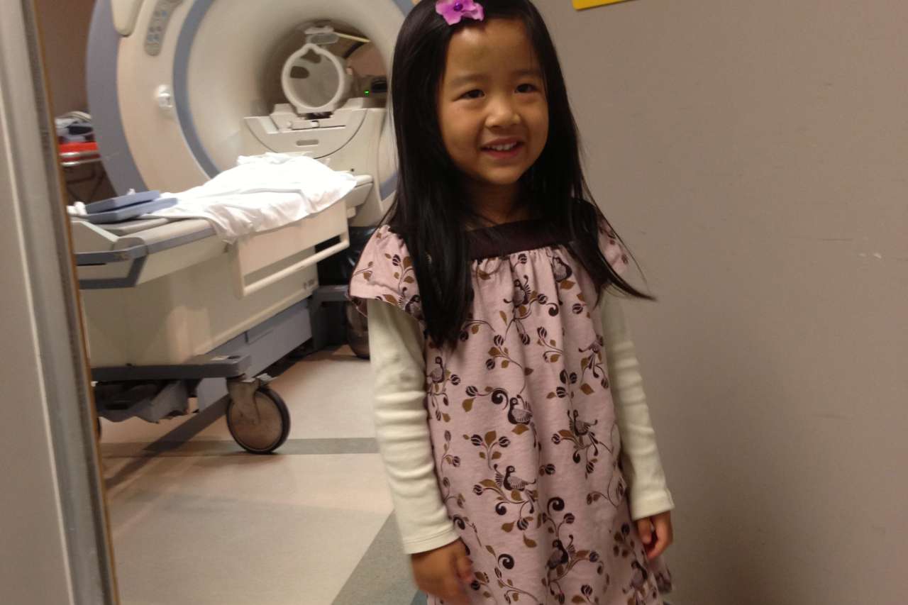 Sabrina Cheung in front of an MRI machine