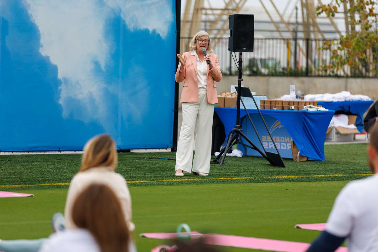 Barb Jagels speaks to the group of participants at the Chargers practice facility.