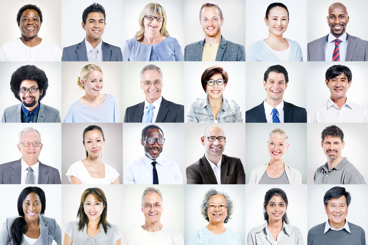 a collage of 24 business professionals looking at the camera in front of a white background