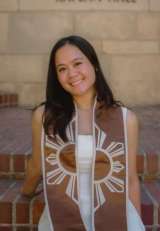 Sophie Viray, wearing a brown graduation stole and a white dress.