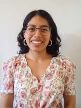 Headshot of Melissa who has brown hair and wears glasses.