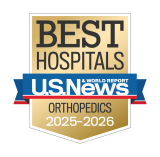 Gold badge with "Best Hospitals" at the top, a blue ribbon with "U.S. News & World Report," and "Orthopedics 2025-2026" below.