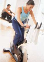 Woman riding exercise bike