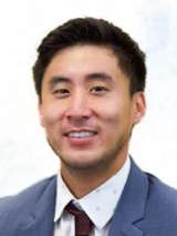 headshot of Christopher Lee in blue suit