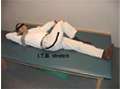 Stretching the iliotibial band (ITB) in the supine position.