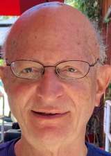 Headshot of Jason Kogan, wearing glasses.