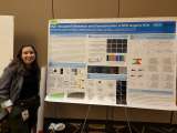 Jacqui Marting smiling at the camera as she stands by the display board for her project