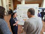 Kathie Ngo shows her display to attendees at Neurology Science Day 2024