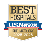 Gold badge with "Best Hospitals" at the top, a blue ribbon with "U.S. News & World Report," and "Rheumatology 2025-2026" below.