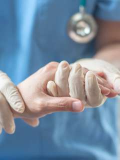 Doctor holding patient hand