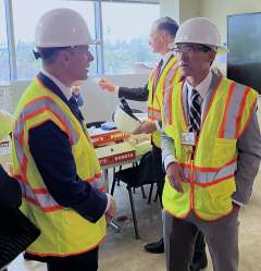 Chief Medical Officer Dr. Erick Cheung and Chief Nursing Officer Patrick Loney of the Stewart and Lynda Resnick Neuropsychiatric Hospital at UCLA don hard hats in preparation for a tour of the construction site.