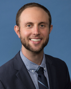 headshot of Marc J. Weintraub, PhD in an indoor setting in front of a blue background