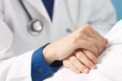 Doctor holding patient's hand