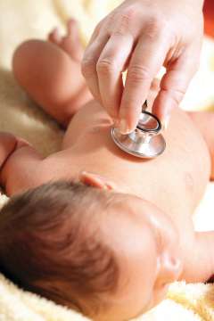 Checking baby's heartbeat with stethoscope