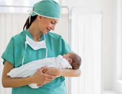 Nurse holding newborn