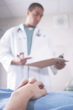 Doctor reading clipboard