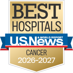Gold badge with "Best Hospitals" at the top, a blue ribbon with "U.S. News & World Report," and "Cancer 2026-2027" below.