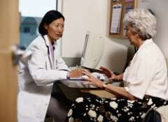 provider in front of computer talking to patient