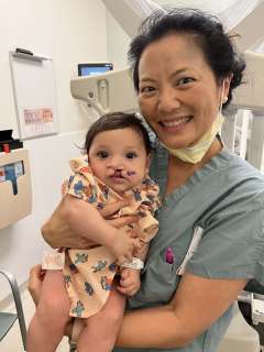 Doctor Justine Lee holds baby Kane Contreras