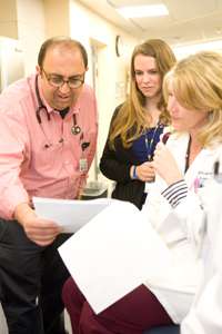 Doctor and nurses looking at document