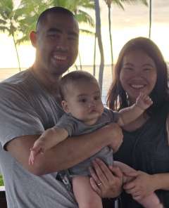 Picture of Eileen Nguyen, MD, PhD with her husband and her baby