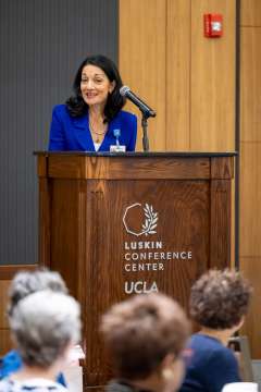 Johnese Spisso speaking at a luncheon.