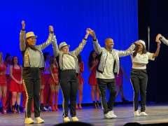 DAPM Mail Assistant, Kathy Good, taking a bow at dance performance with fellow dancers