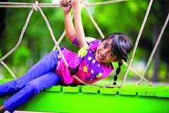 girl sitting on green bridge
