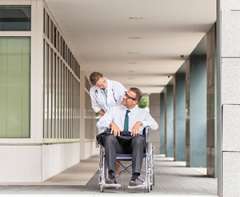 provider pushing patient in wheelchair