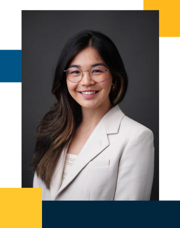 Professional headshot of person wearing glasses and white blazer, smiling