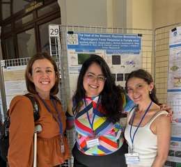 Kelly Vranich with her peer and mentor posing in front of her research poster.