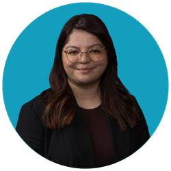 Smiling woman with glasses in a black blazer on teal circular background.