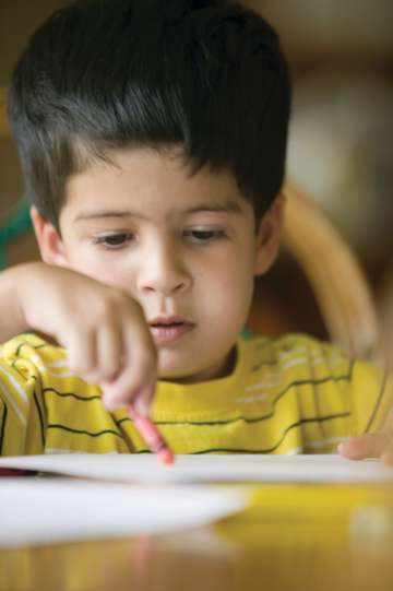 Child coloring at a table