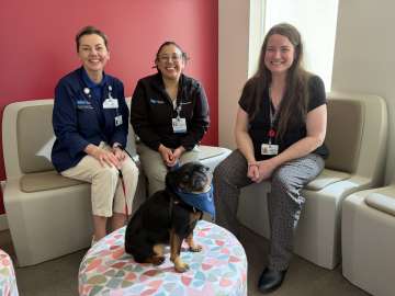 Monkey the Therapy Dog with handler Olga and 2 Resnick Staff