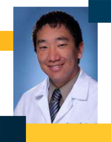 Dr. Ed Lee wearing white lab coat with shirt and tie