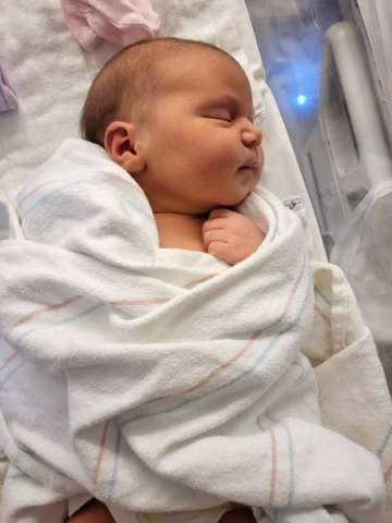 Infant Daria Bogdan wrapped in a blanket
