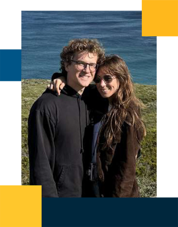 Andrew Roney and partner with grass and ocean in the background