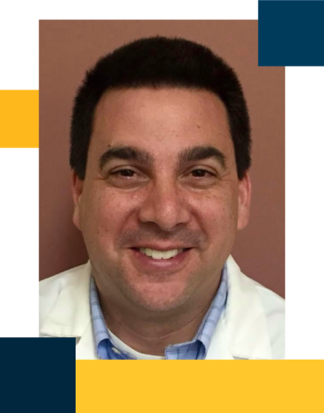 Dr. Neil paige wearing white coat and taracota background