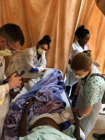 Doctors treating a patient in bed