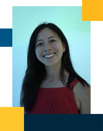 Vi Nguyen wearing a red blouse with a blue light in the background
