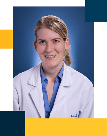 Dr. Wendy Simon wearing white coat with blue button down