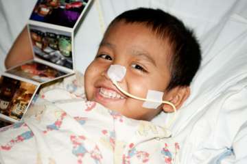 Boy smiling in hospital bed